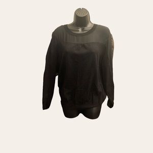 Joseph A. All black long sleeve knit top with sheer sleeves.